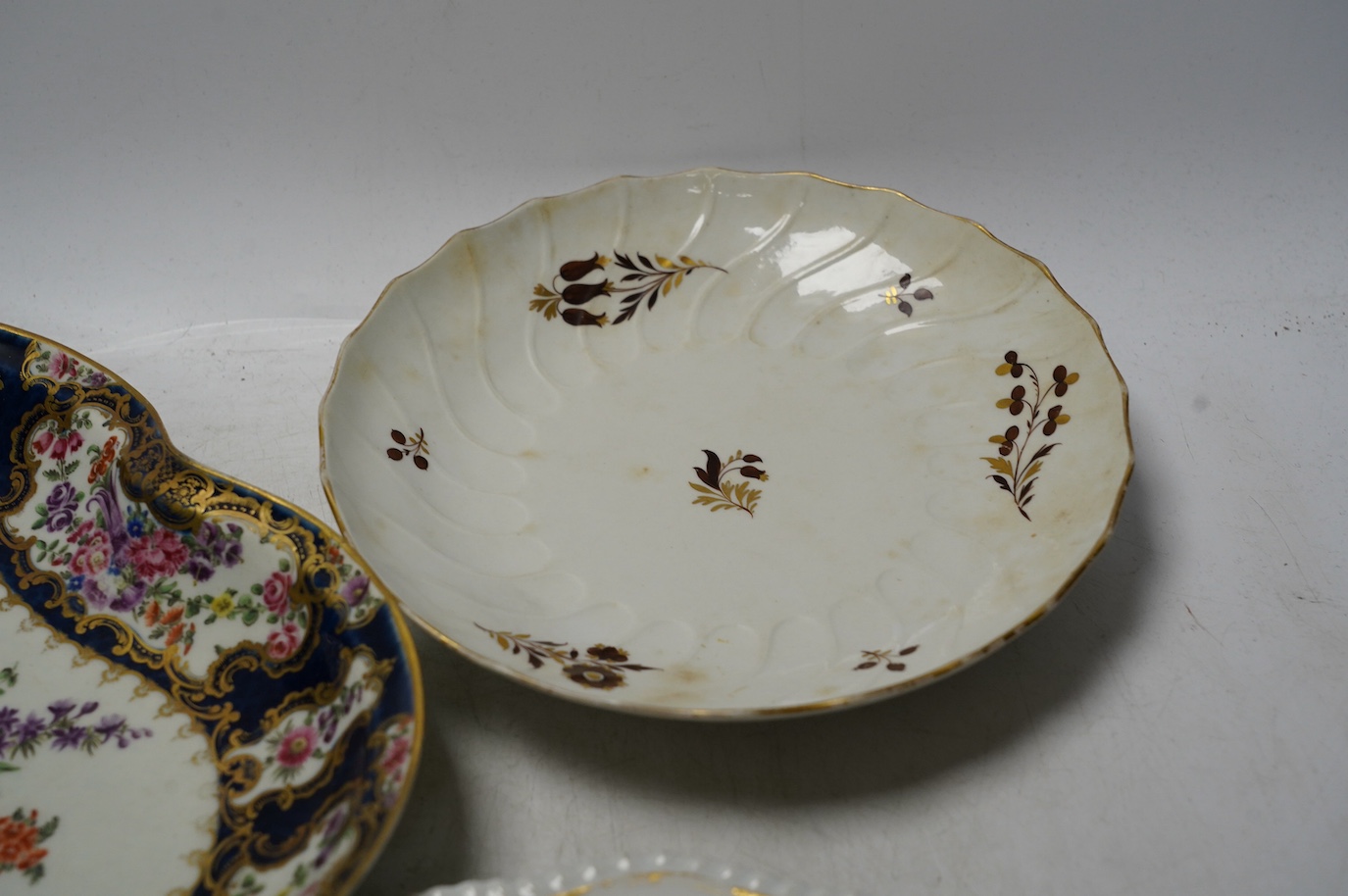 An 18th century Worcester dessert dish and two later Barr Flight & Barr plates, larger 26cm. Condition - worn